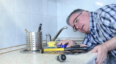 Old man Fixes a Sink Stock Footage 49219838