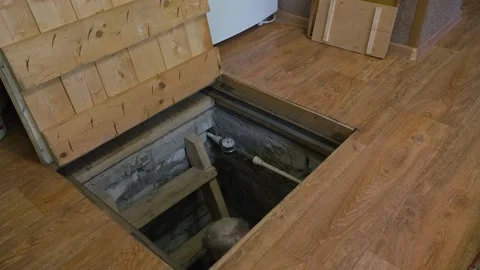 An old man with glasses climbs out of the basement Stock Footage 167324959