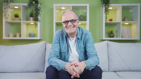 Old man with glasses looks at camera and smiles. Stock Footage 237795544