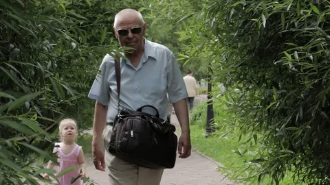 The old man going through the summer garden Stock Footage 77627411