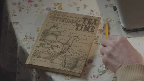 Old man hand lay out pencil, eraser and notepad on table and open laptop Stock Footage 195447139