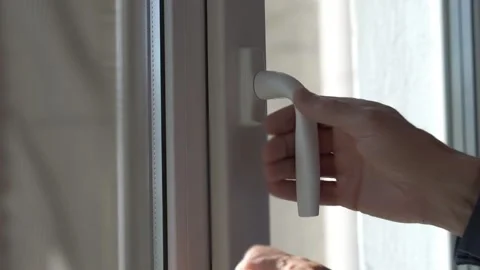 Old man hand opens plastic window handle to air room closeup Stock-Footage 134998182