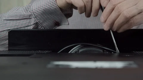 Old man hands unscrew outdated black television set cover Stock Footage 126761427