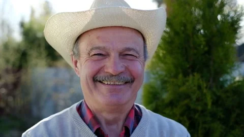 Old man in hat smiling standing outdoor Stock Footage 107832599