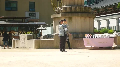 Old man with hat using phone take photo morning Stock Footage 232643189