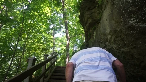 Old man having trouble going up step wooden stairs Stock Footage 111426009