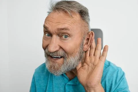 Old man with hearing problems in hearing clinic, hearing impaired and holding Foto stock