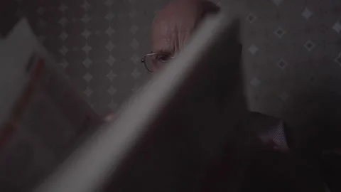 Old man with high temples in glasses reads and turns page Stock Footage 239165828