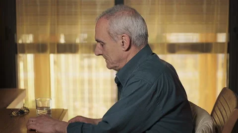 Old man in his bedrooom while takes pills with water Stock Footage 63372493
