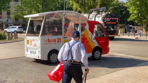 Old man with his cane missing the small electric shuttle La Diabline in Aix Stock Footage 160123436