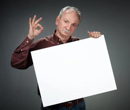Old man holding empty bill board Stock Photos