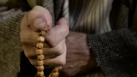 Old man holding prayer beads in hand Video stock 80317229