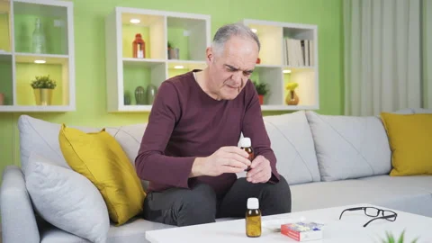 Old man with itchy ear. He scratches his ear with his hand and is uncomfortable. Stock Footage 235445344