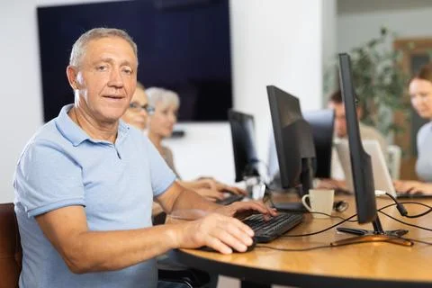 Old man learning computer programs in training room 写真素材