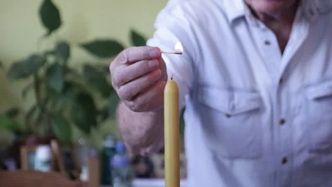 Old Man Lighting A Candle Video stock 131056964