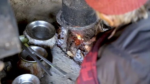 An old man lighting the fire on old oven Stock Footage 156010172
