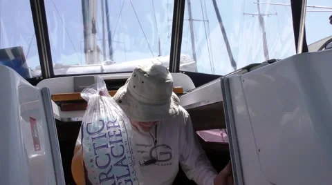 Old man loading ice in a sailboat cabin Stock Footage 67515585