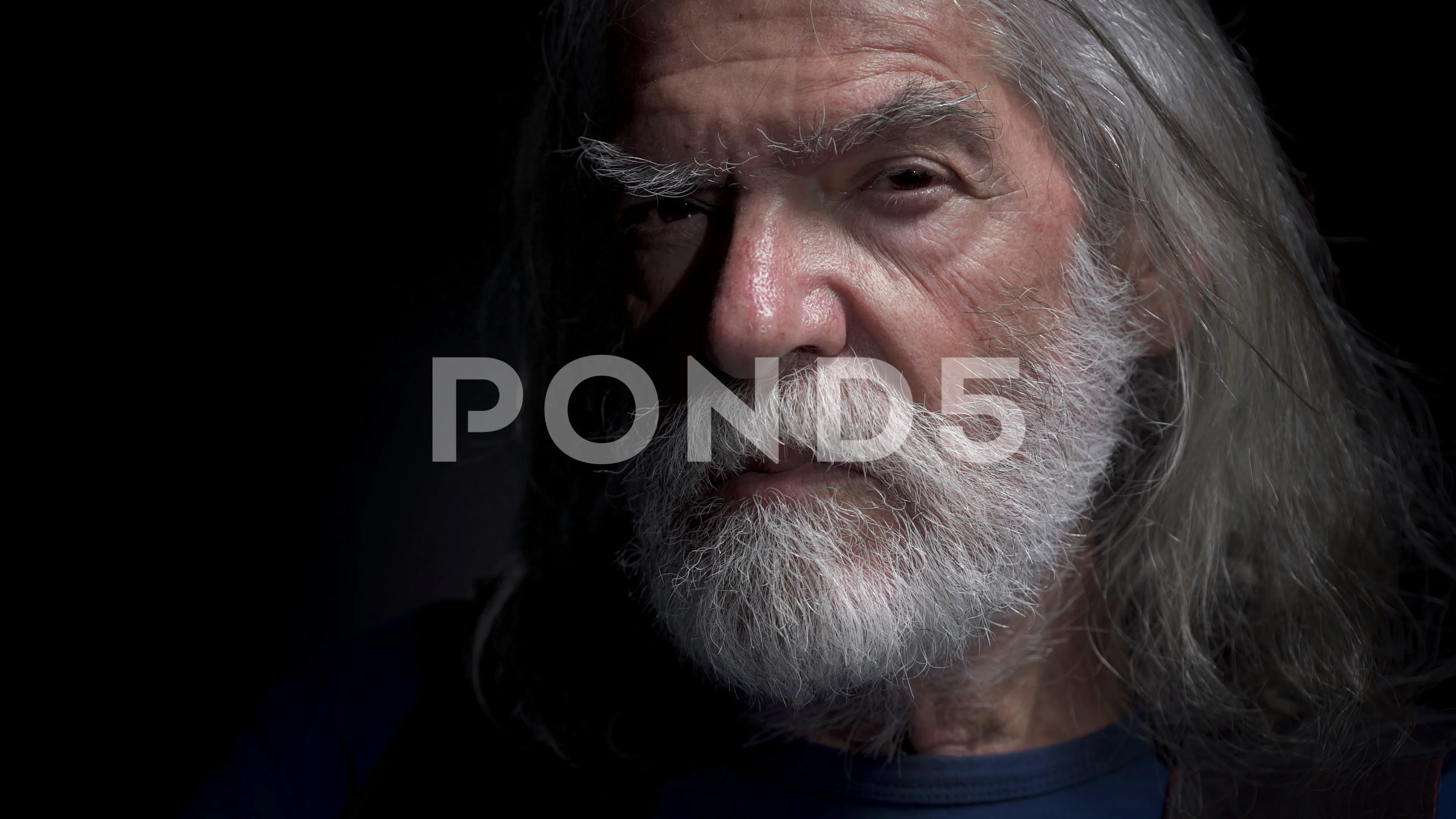 Old man with long white beard looks thre... | Stock Video | Pond5