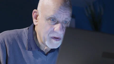 Old man looking at laptop at night working seriously and focused. Stock Footage 232228883