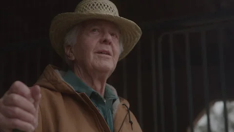 Old Man Looking Out From Barn Holding Pitchfork Stock Footage 270334819