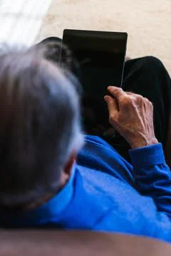 Old man looking something to a tablet Stock Photos