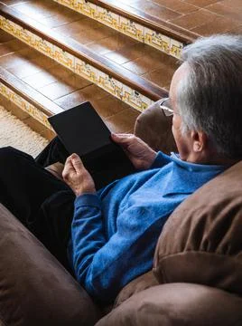 Old man looking a tablet in house Stock Photos