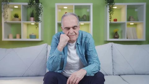 The old man looks helplessly at the camera. Stock Footage 237793760