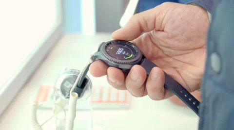 Old Man Looks Modern High-Tech Wrist Watches Old Man Holding a Clock Hours Stock Footage 68385025