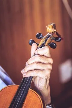 Old man (luthier) playing the violin with aged hands Stock Photos