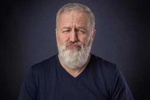 Old man making grimace like a spoiled child Stock Photos