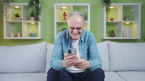 The old man is making a video call on the phone. Stock Footage 237794444