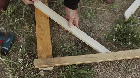 Old man making a wooden construction Video stock 56869739