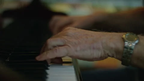 An old man masterfully play a fast pace perform of music on a black piano. Stock Footage 194513306