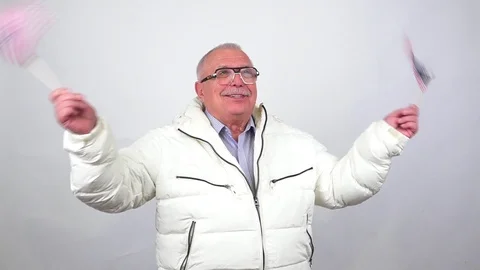 Old man with mustache in jacket smiles waves small US flags Stock Footage 107575513