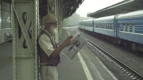 Old Man With Newspaper On Train Station Video stock 64146397