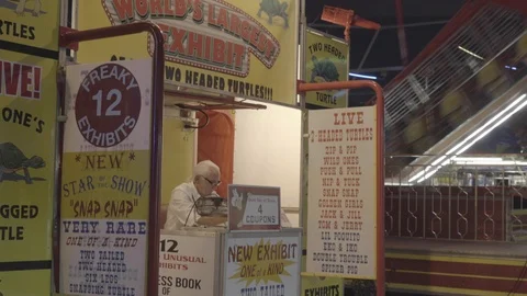 Old Man Occupies his Post at the Fair/Carnival Stock Footage 100963882