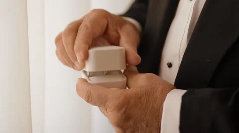 Old man open white box with wedding rings Stock Footage 61182672