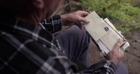 Old man opening stack of letters and reading over shoulder Video stock 122471360
