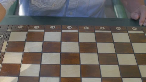 Old man opens the chess game with white pawn on E4 Stock Footage 118711109
