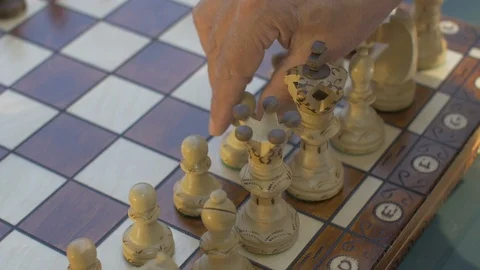 Old man opens the chess game with white pawn on E4 Stock Footage 118714183