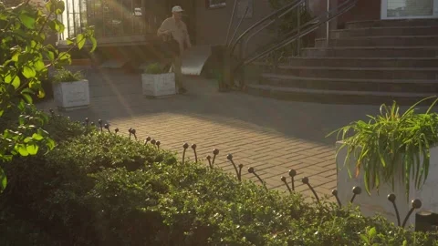 Old man passes down the road with a bag in his hand early in the morning Stock Footage 139083441