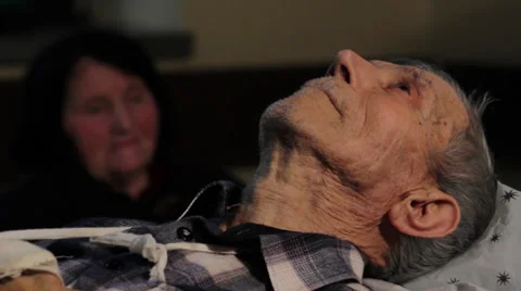 Old man, patient with broken arm lying down on table in ambulance.Close up face. Stock Footage 34957790