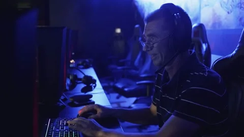 Old man playing on computer late at night in Modern computer club. Stock Footage 136392124