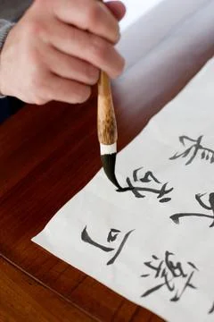 An old man practices calligraphy 스톡 사진