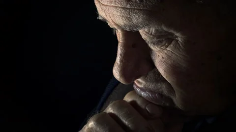 Old man praying in the dark: elderly man praying in the darkness Video stock 56152389