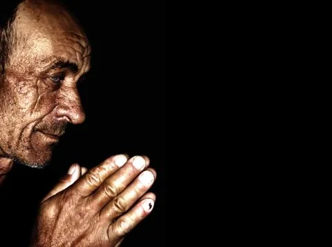 Old man praying Stock Photos