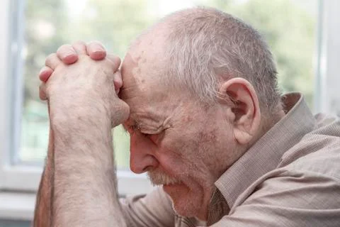 Old man praying Stock Photos