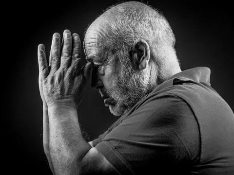 Old man praying Stock Photos