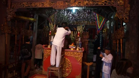 Old man preparing worship offerings on altar Stock Footage 87488044