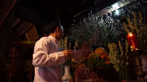 Old man preparing worship offerings on altar Stock Footage 87488075